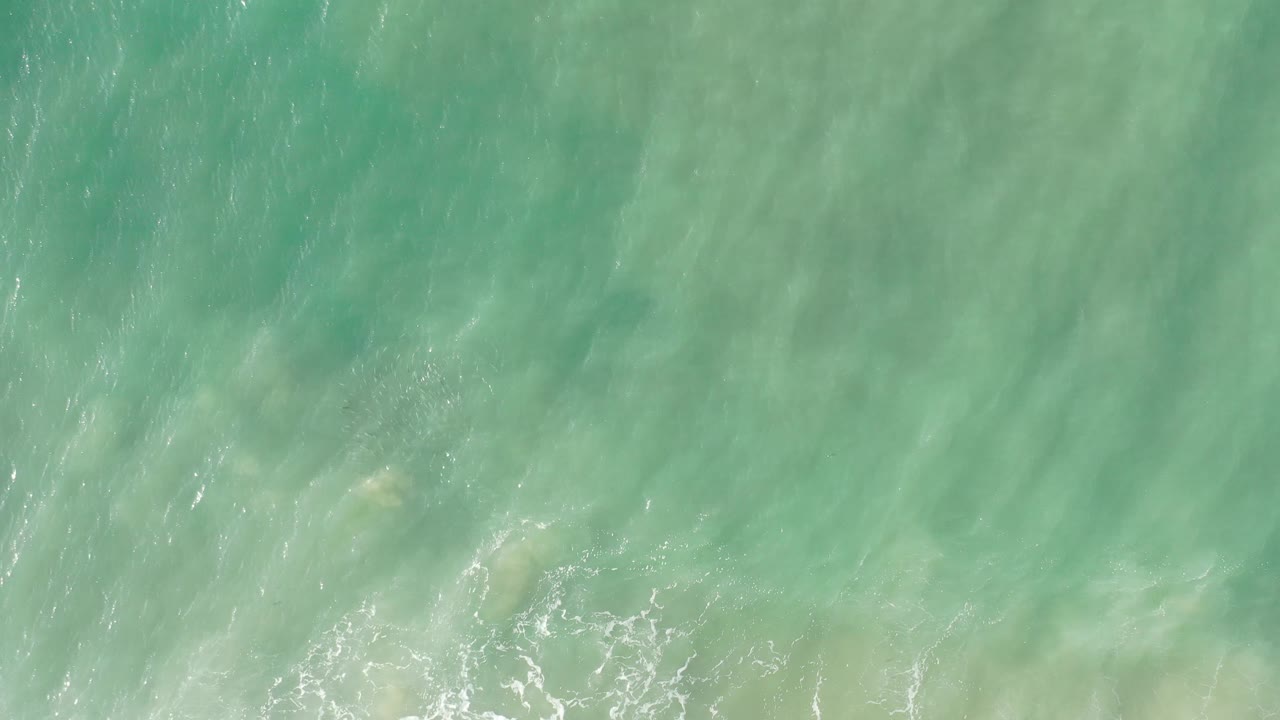 Turquoise water with faint white foam near the lower edge.