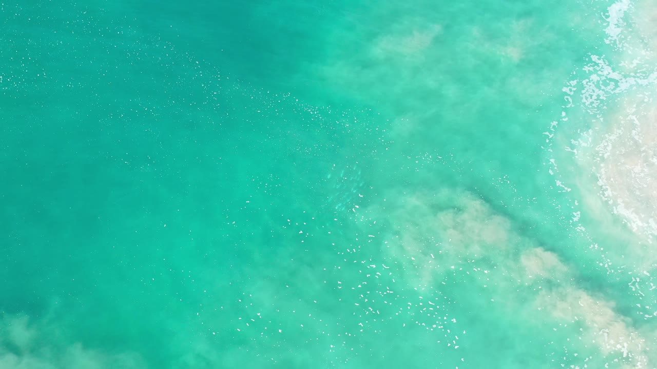 Aerial sea water with foam band and green-blue color variation