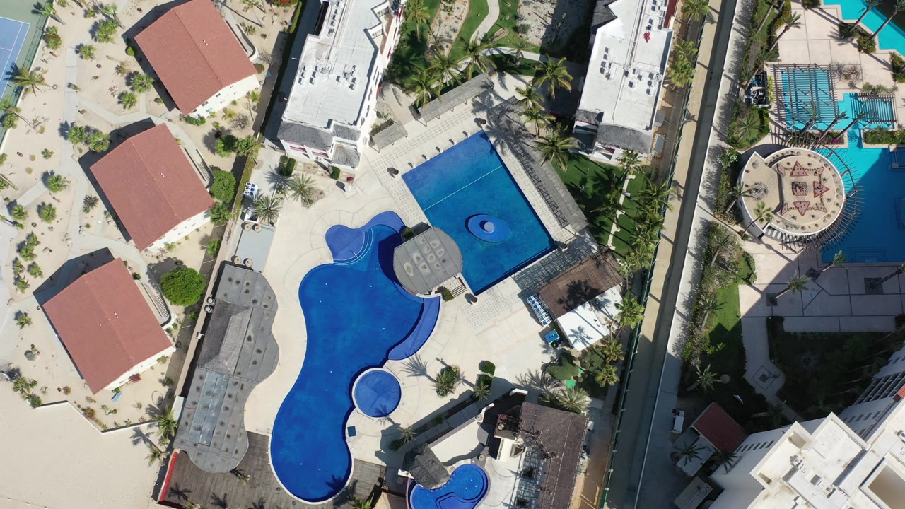 Overhead blue pools with circular feature and resort walkways.