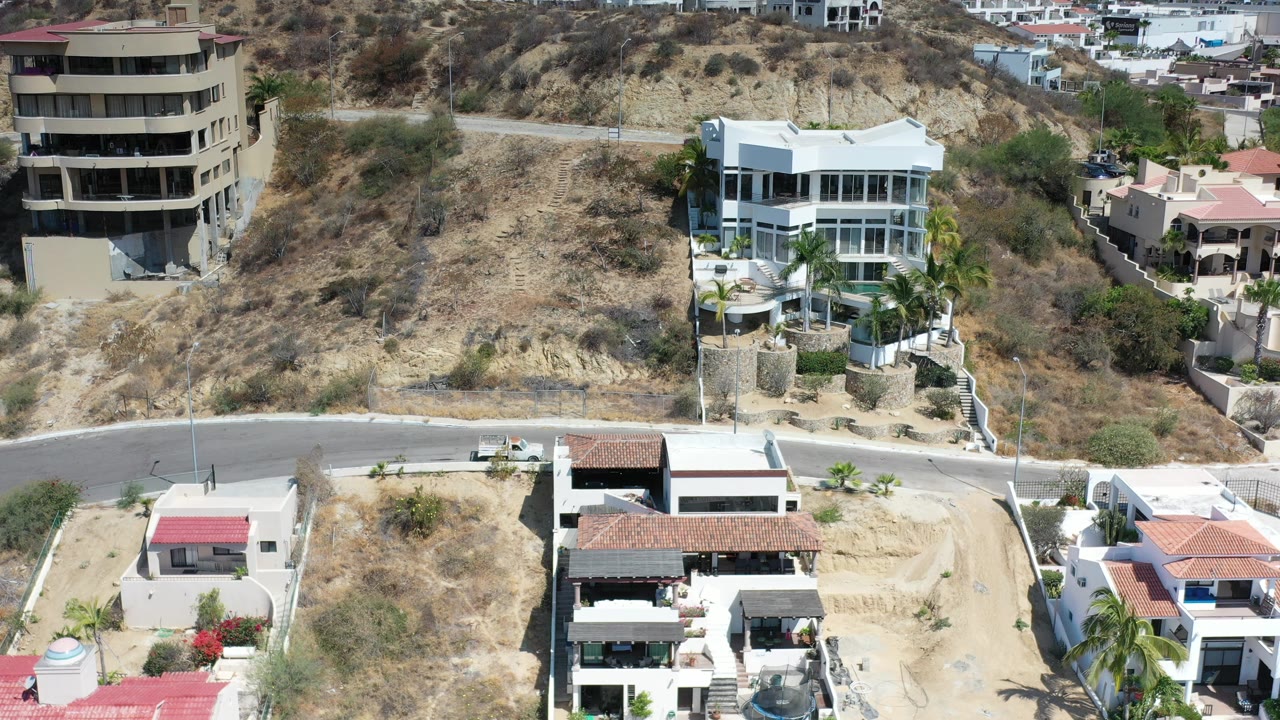 Elevated view of homes, road, and dry hillside