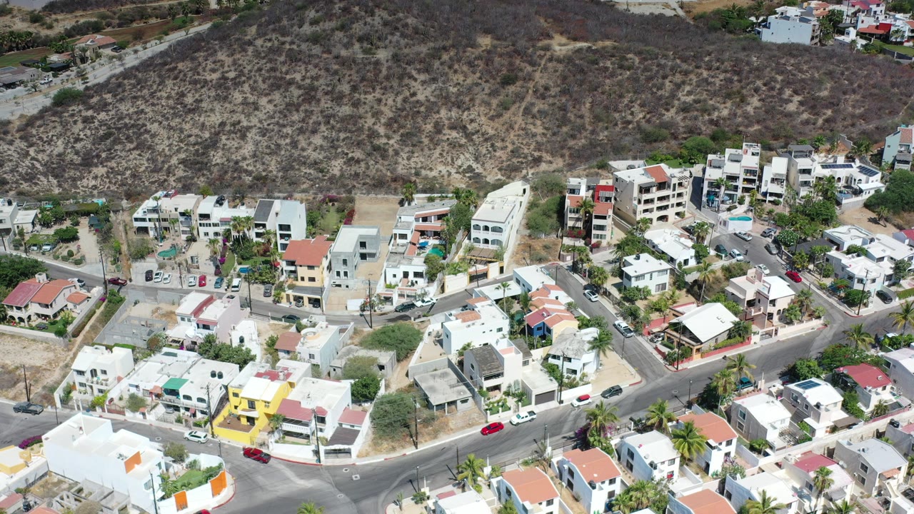 Aerial view of hillside homes and curving residential roads.