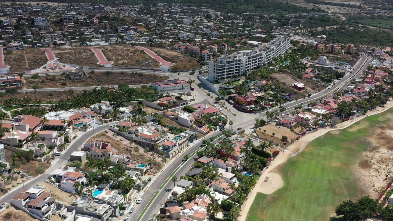 Aerial view of homes, roads, and a golf fairway.