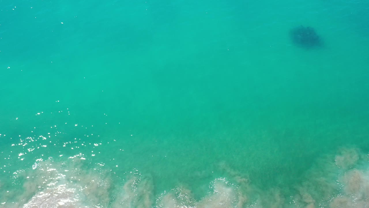 Overhead ocean water with a dark underwater patch near the upper frame