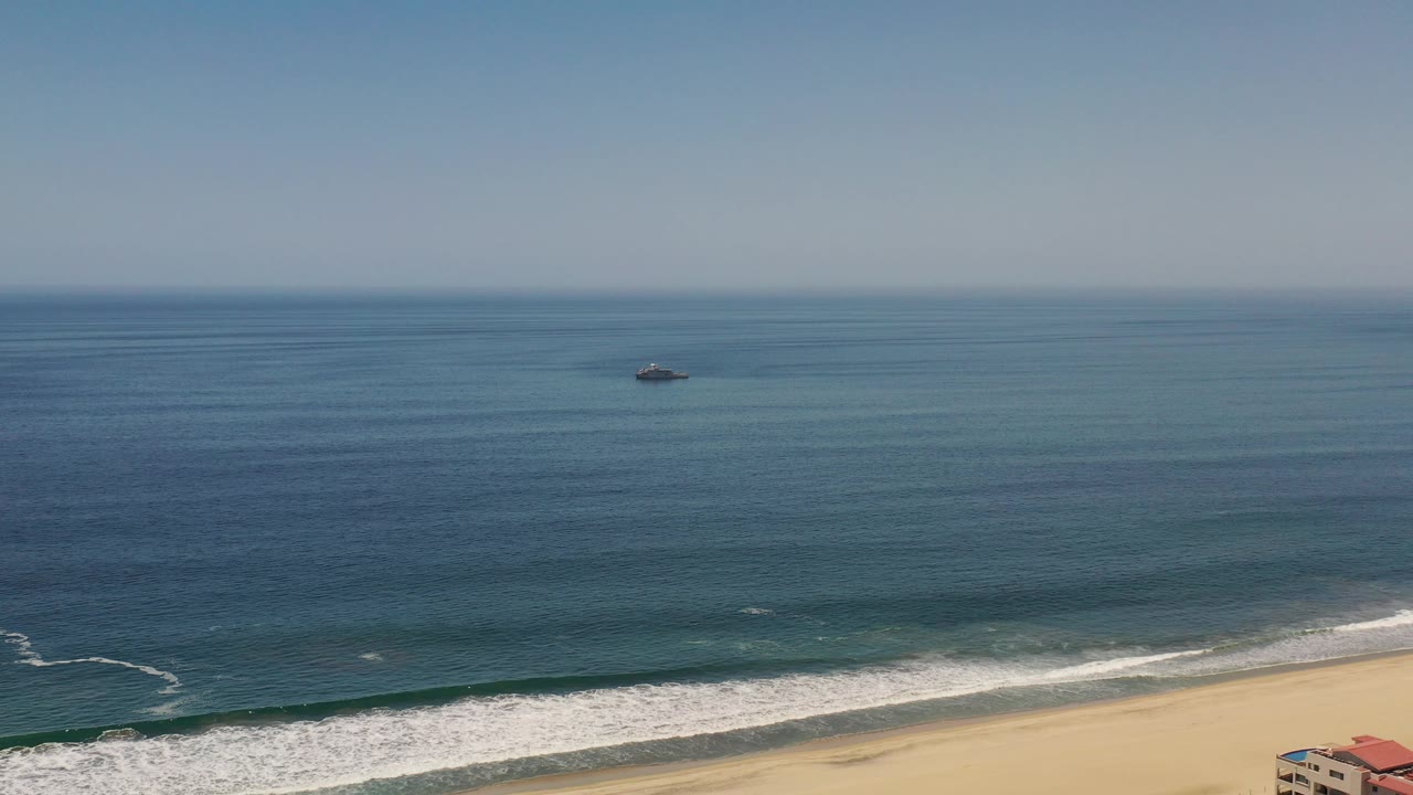 Coastal water and breaking waves with a small object near the horizon side.