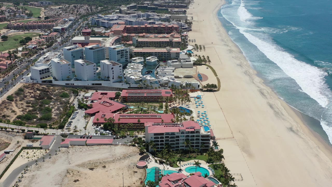 Aerial view of beach resorts beside surf