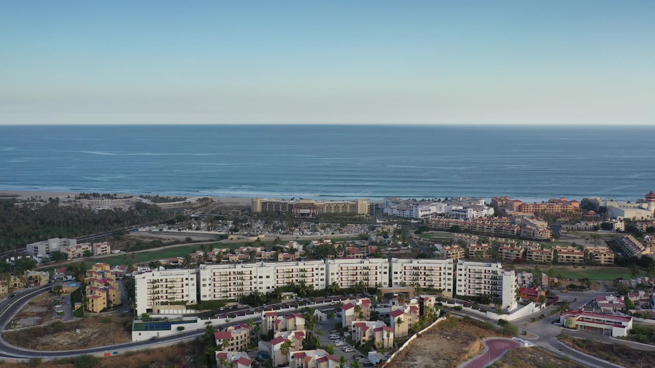 Coastal city blocks under a clear sky and blue sea