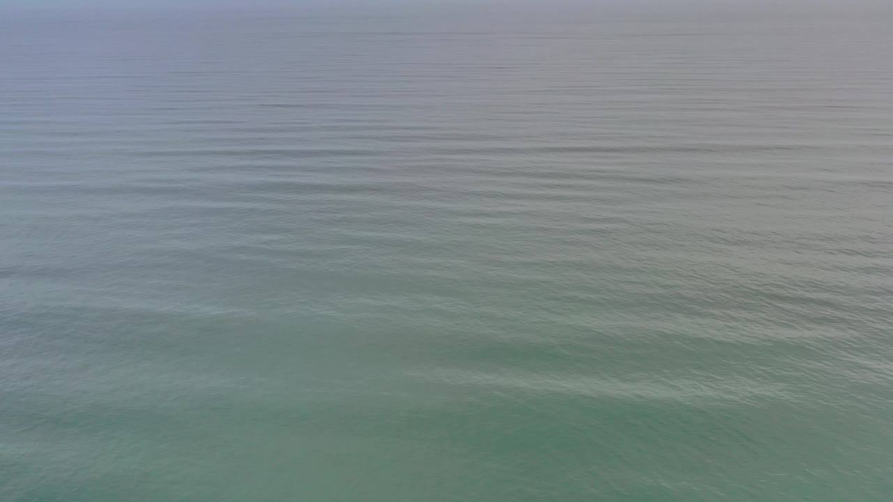 Green-blue ocean water in Los Cabos, Mexico fills the frame at the opening moment, with soft ripples and no visible people.