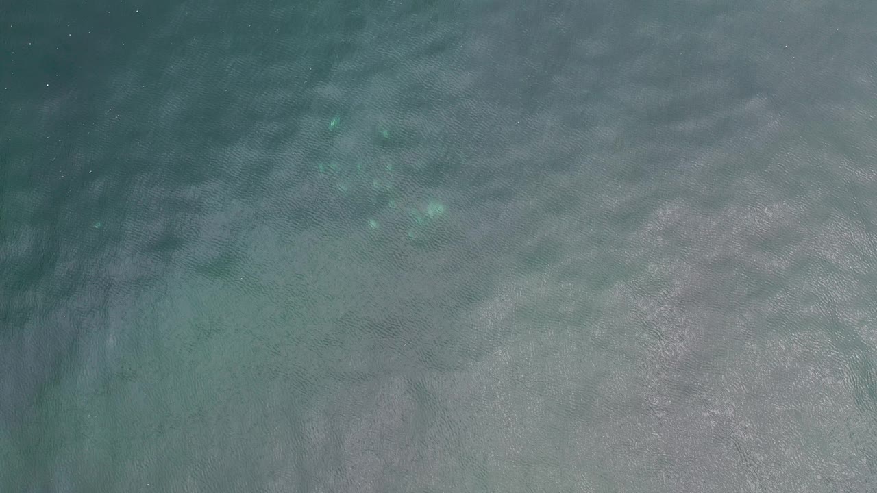 Rippling turquoise-gray water with bright patches
