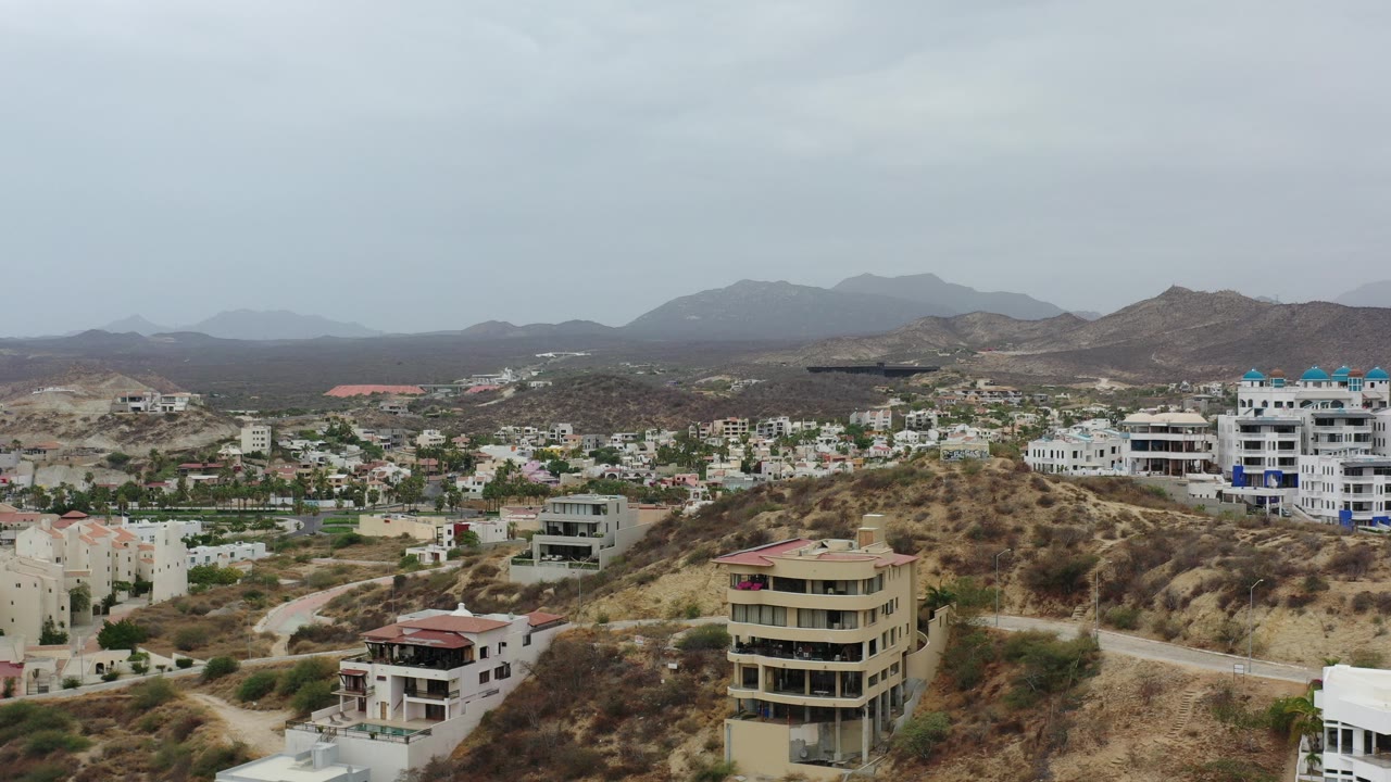 Aerial view of hillside homes under a cloudy sky