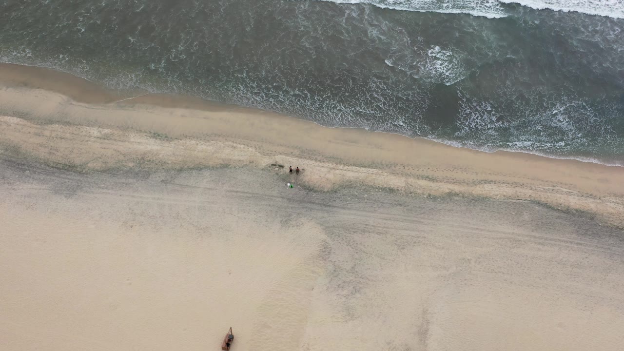 Top-down surf edge and beach sand