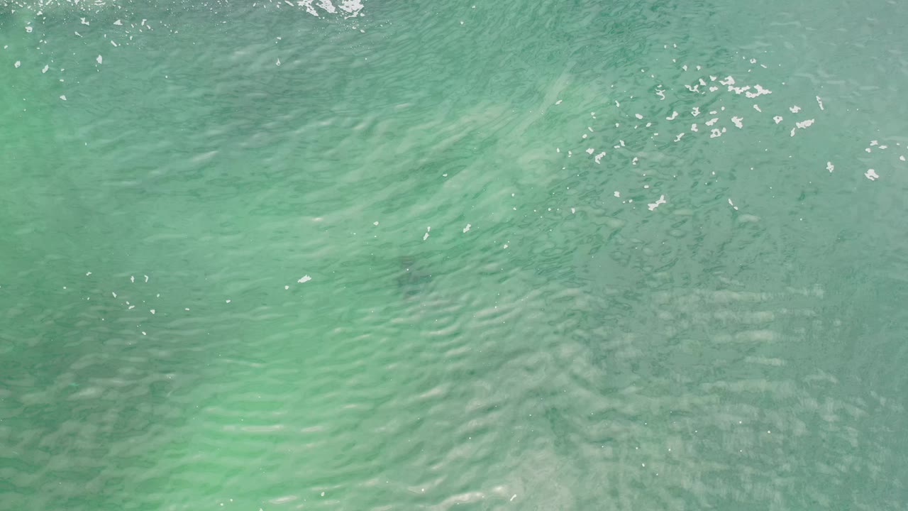 Turquoise Los Cabos ocean water shows diagonal ripple lines, soft underwater tonal shifts, and no visible people or vessels.