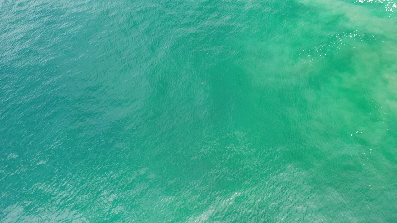 Green blue ocean water fills the frame in Los Cabos, Mexico, with subtle ripples and no visible people.