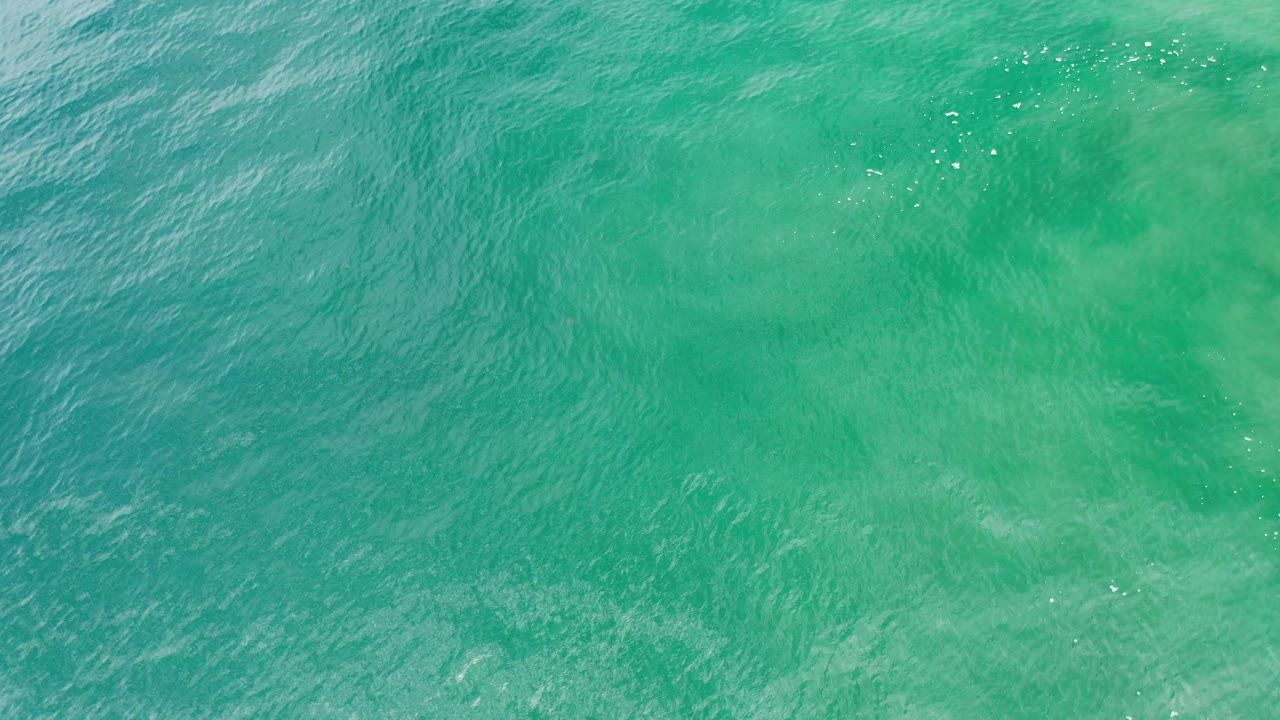 Turquoise water with shimmering surface ripples