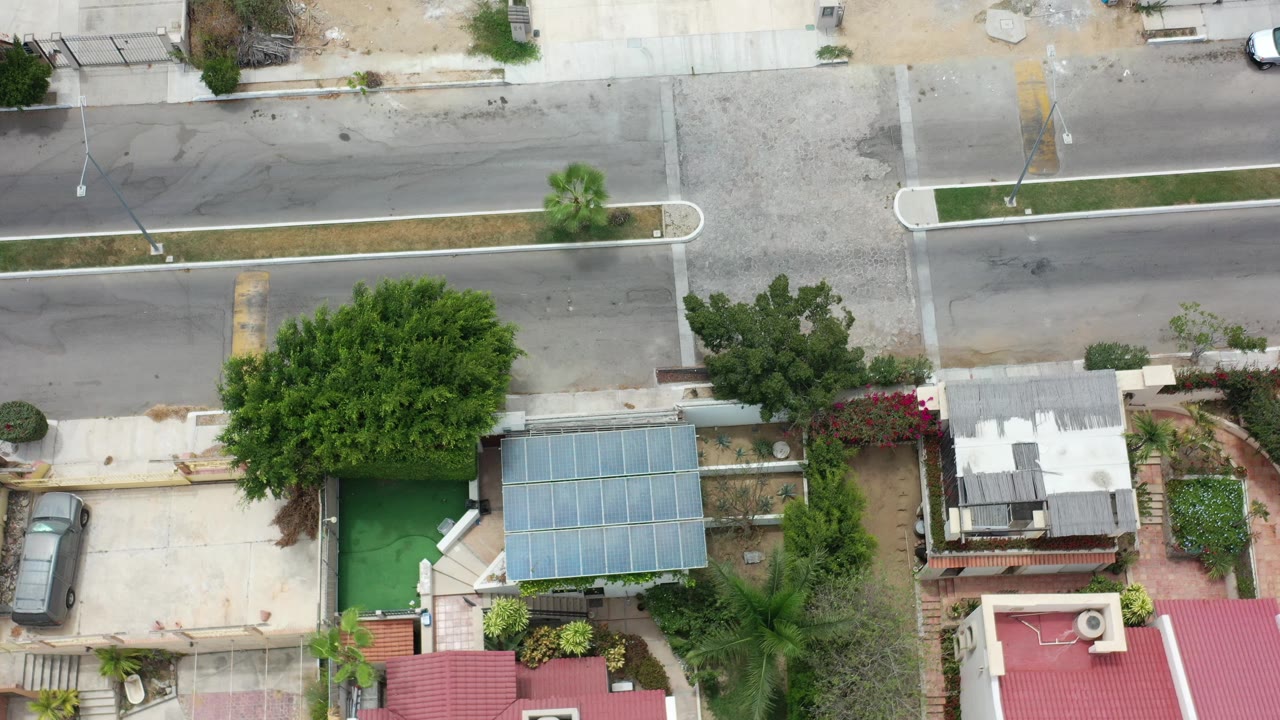 Overhead view of homes, trees, and a road