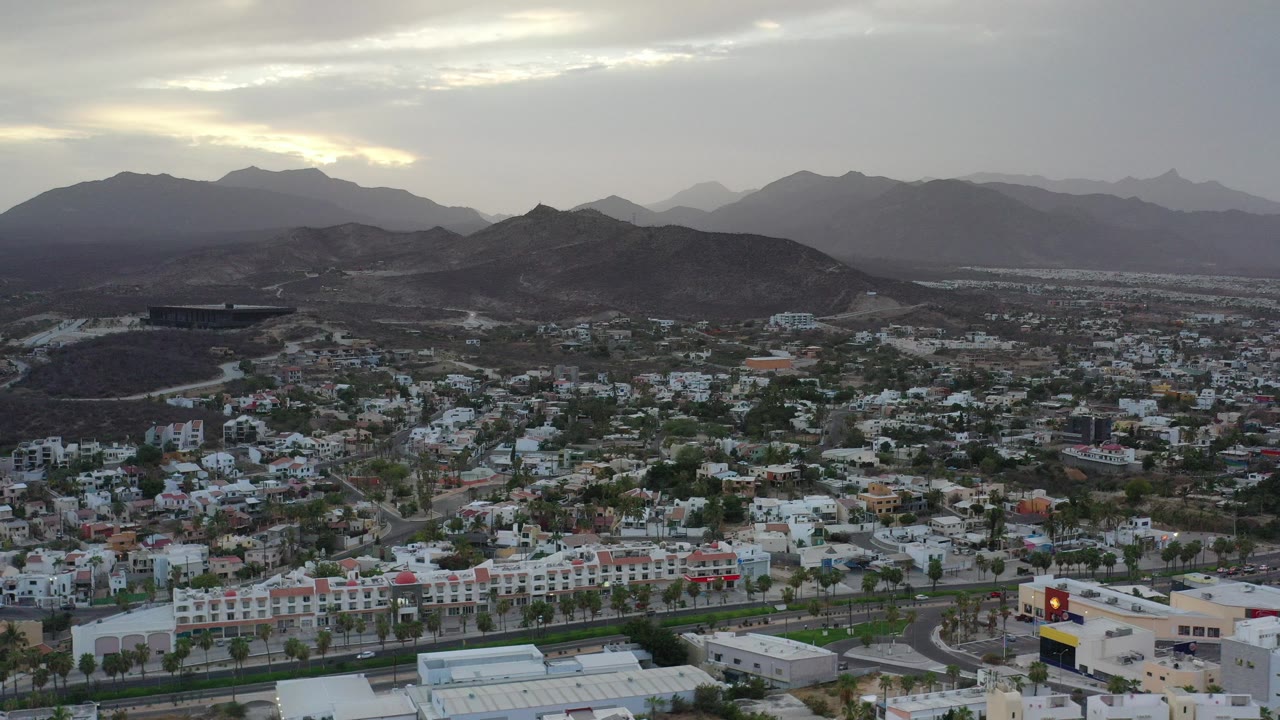 Elevated city view with low hills and cloudy sky