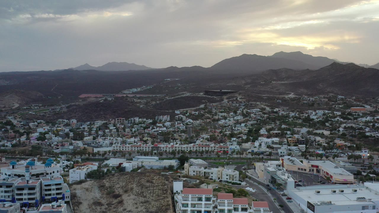 Aerial view of Los Cabos buildings and mountains at early morning.