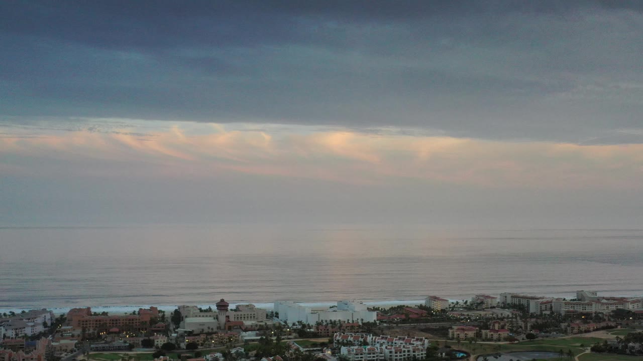 Wide sea and cloud layers over coastal development