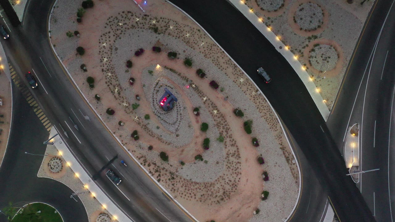 Overhead view of curved roads around desert landscaping
