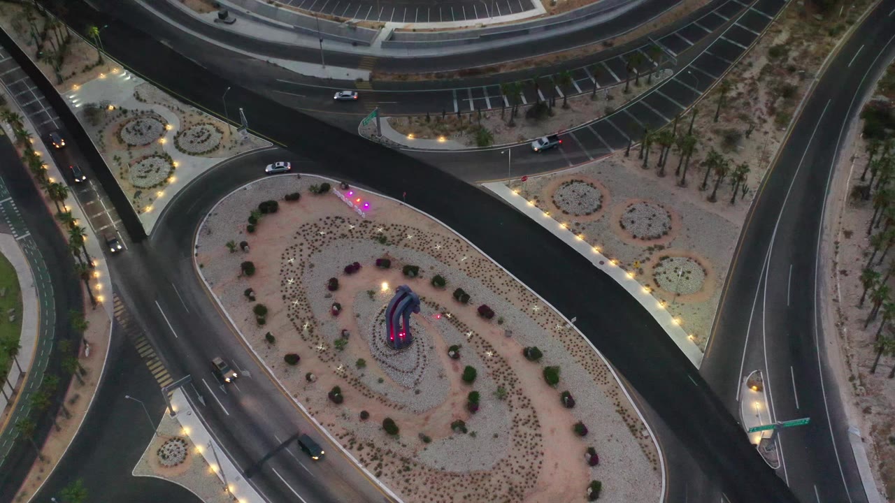 Aerial roundabout with cars on surrounding bypass roads.