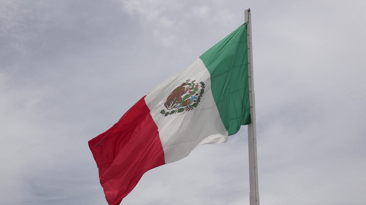 Mexican flag lifted high with red panel extended