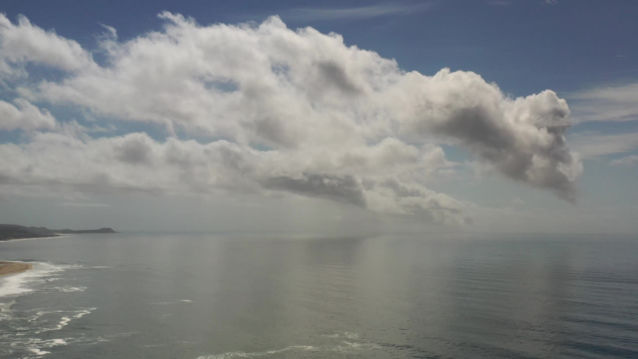 Open ocean beneath large white clouds