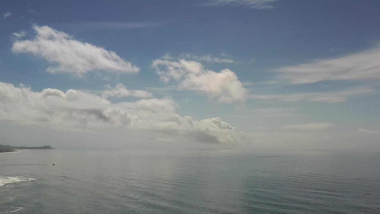 Los Cabos water and sky fill the frame, with the left shoreline slightly inside the frame and no visible people.
