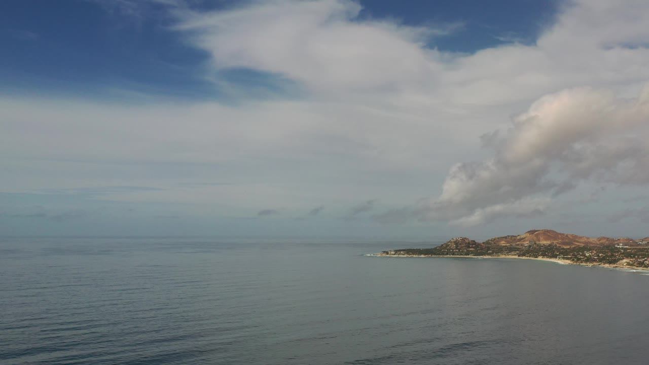 Coastal hills beneath a broad cloud bank