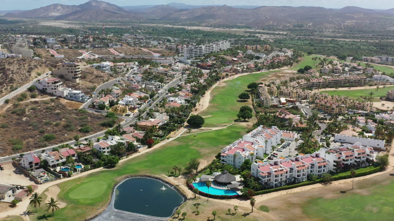 Aerial view of a golf course running through a residential community.