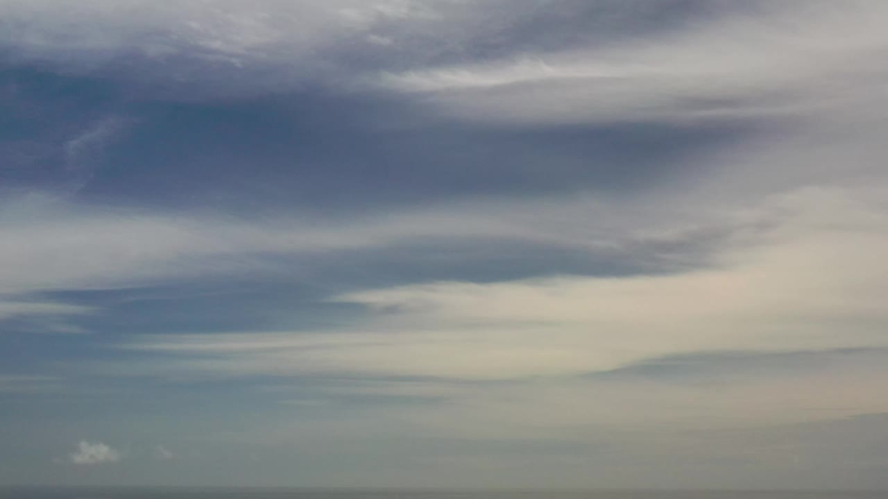 Los Cabos ocean view with layered white and gray clouds filling most of the frame and no visible people.