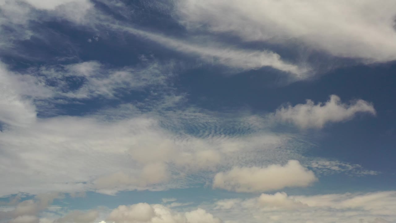 Overhead-looking sky view with white cloud layers.