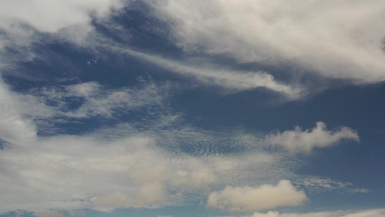 White clouds over a deep blue sky.