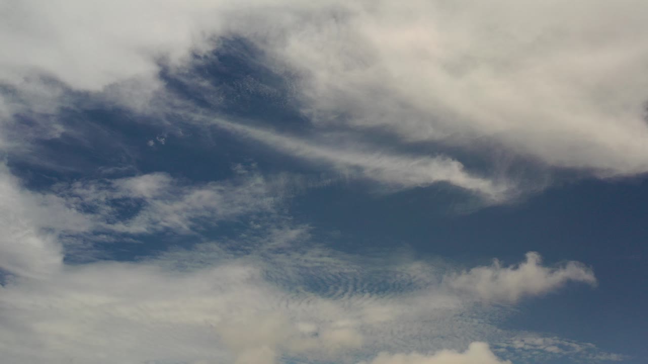 Dark blue sky with white and gray clouds.