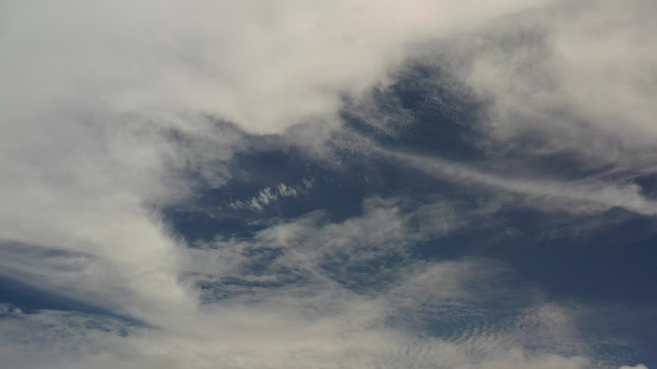 Opening frame of the Los Cabos clip showing white and gray cloud bands over a dark blue sky, with no visible people.