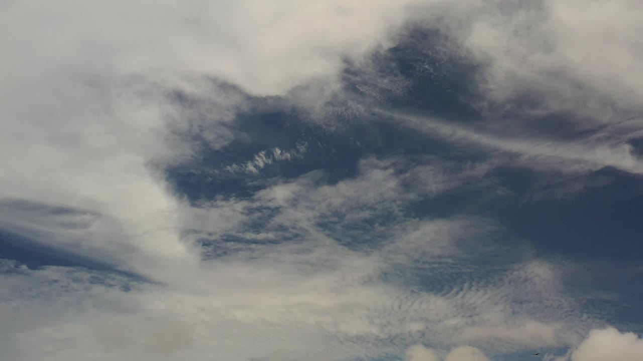 Clouds spread across a blue sky.