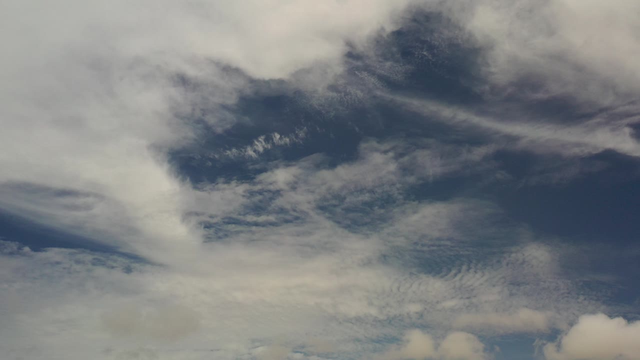 Los Cabos sky filled with layered white and gray cloud cover over blue patches, with no visible people.