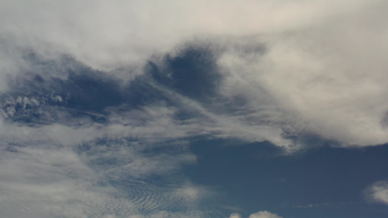 White and gray cloud banks stretch across a blue sky over Los Cabos, Mexico, with no visible people or ground features.