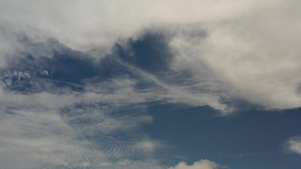 Blue sky with broad white cloud cover overhead.