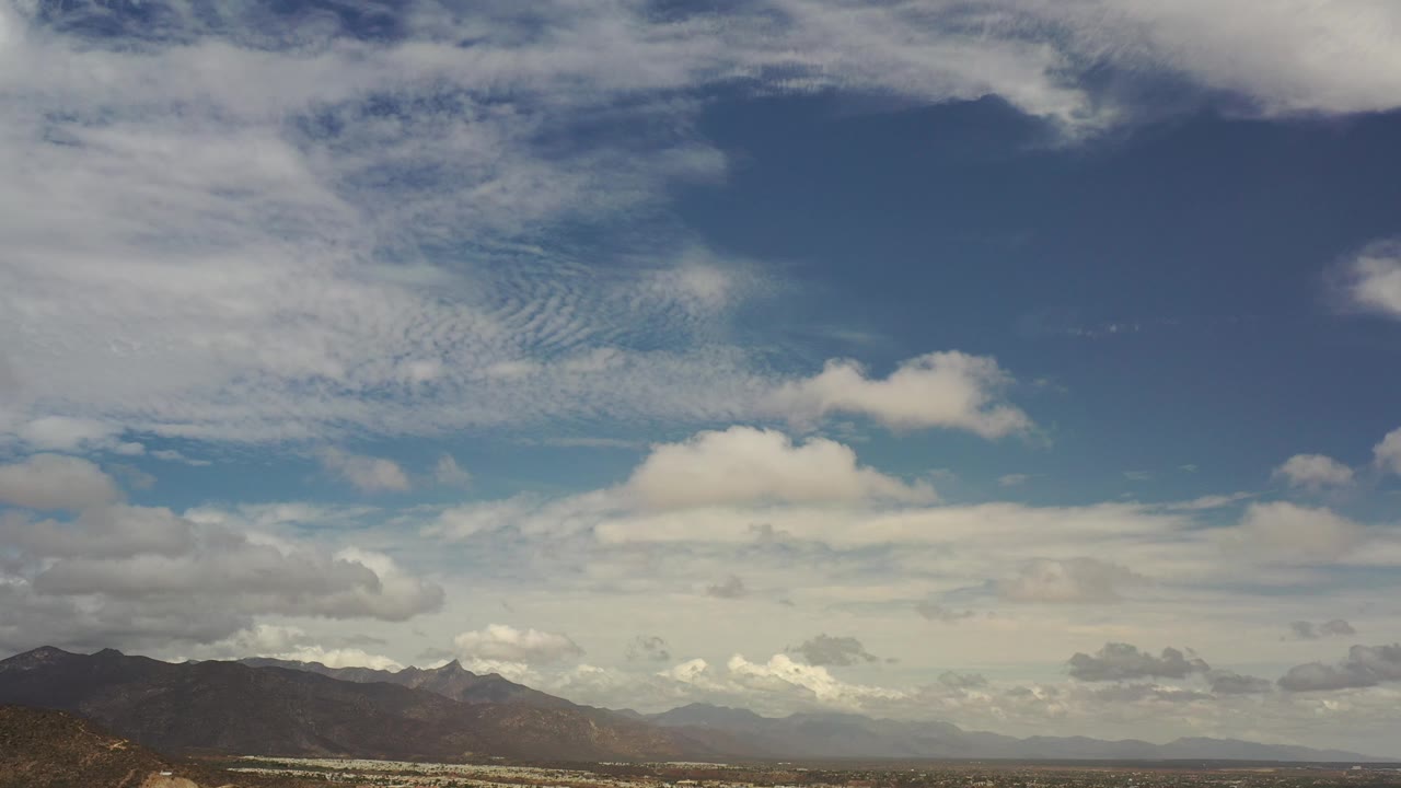 Mountains beneath a bright cloud layer