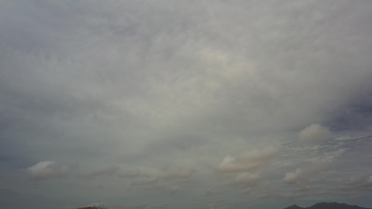 Cloudy sky above a low mountain ridge