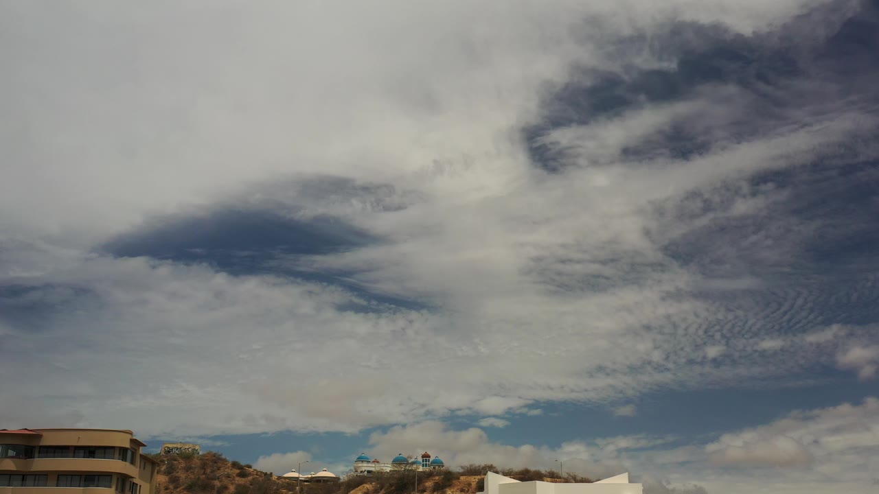 Cloud bank above rounded beige building