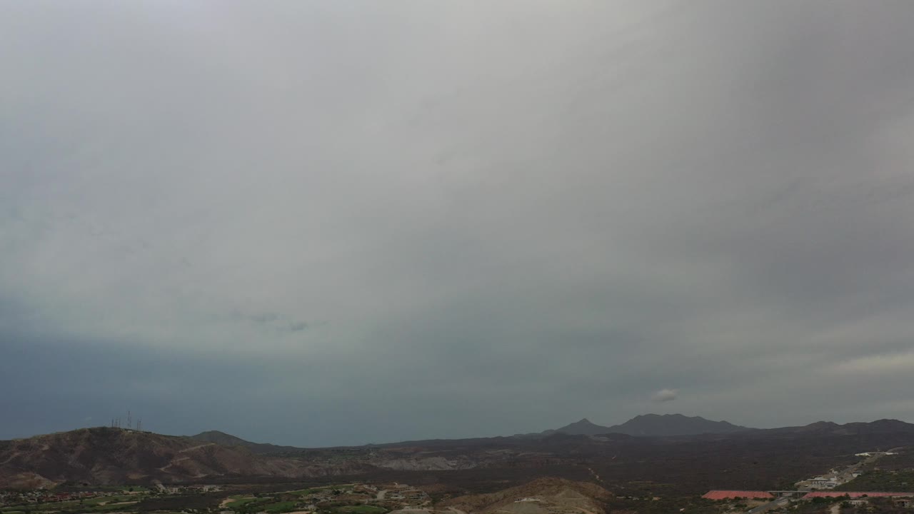 Cloudy mountain skyline with sparse development.
