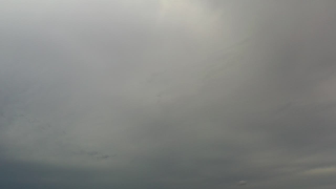 Gray and white clouds filling a bright sky.