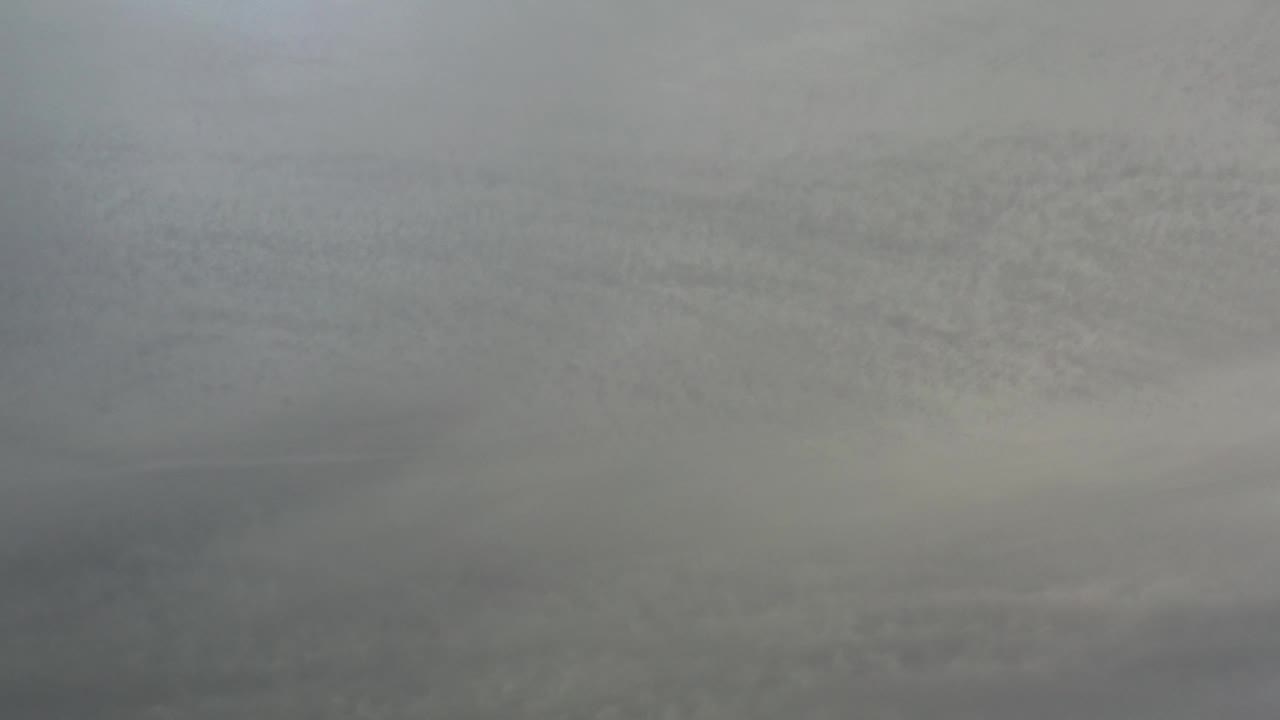 Opening gray textured frame from the Los Cabos Mexico clip, with faint horizontal bands and no visible people.