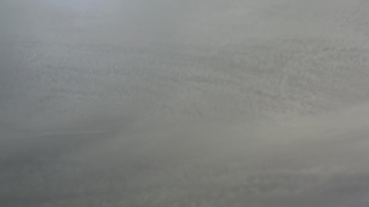 Pale gray surface with blurred tonal variation.