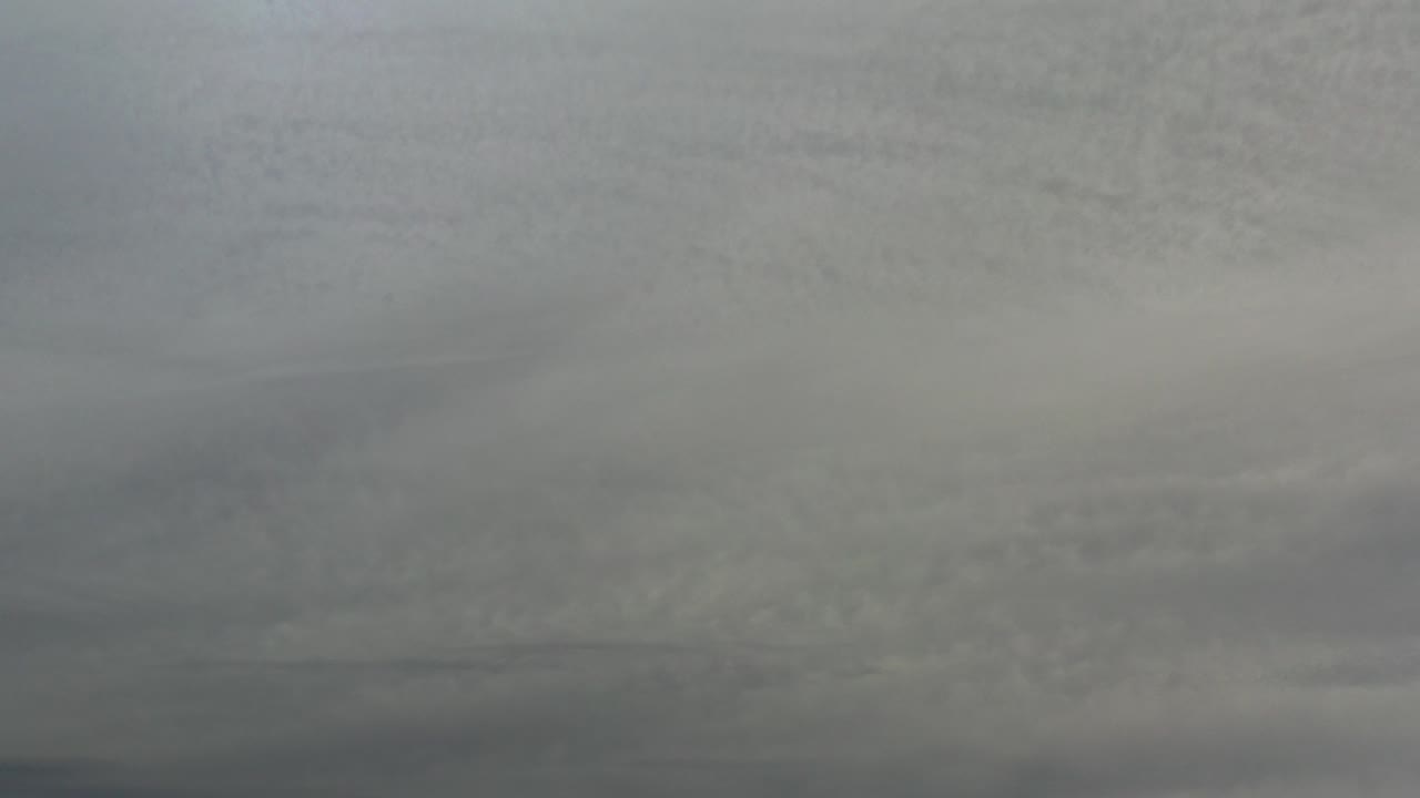 Overcast gray and white cloud layers fill the Los Cabos sky at the start of the clip, with no visible people.