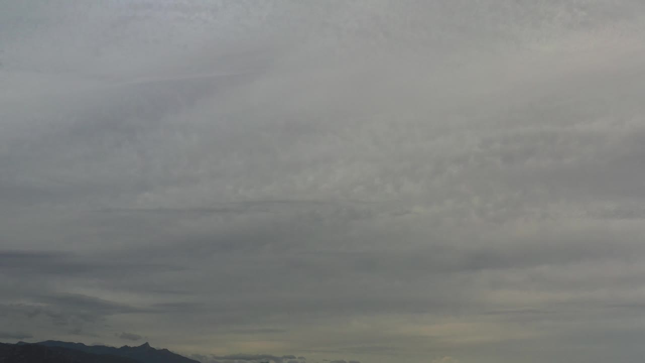 Overcast sky with mountains low in the frame.