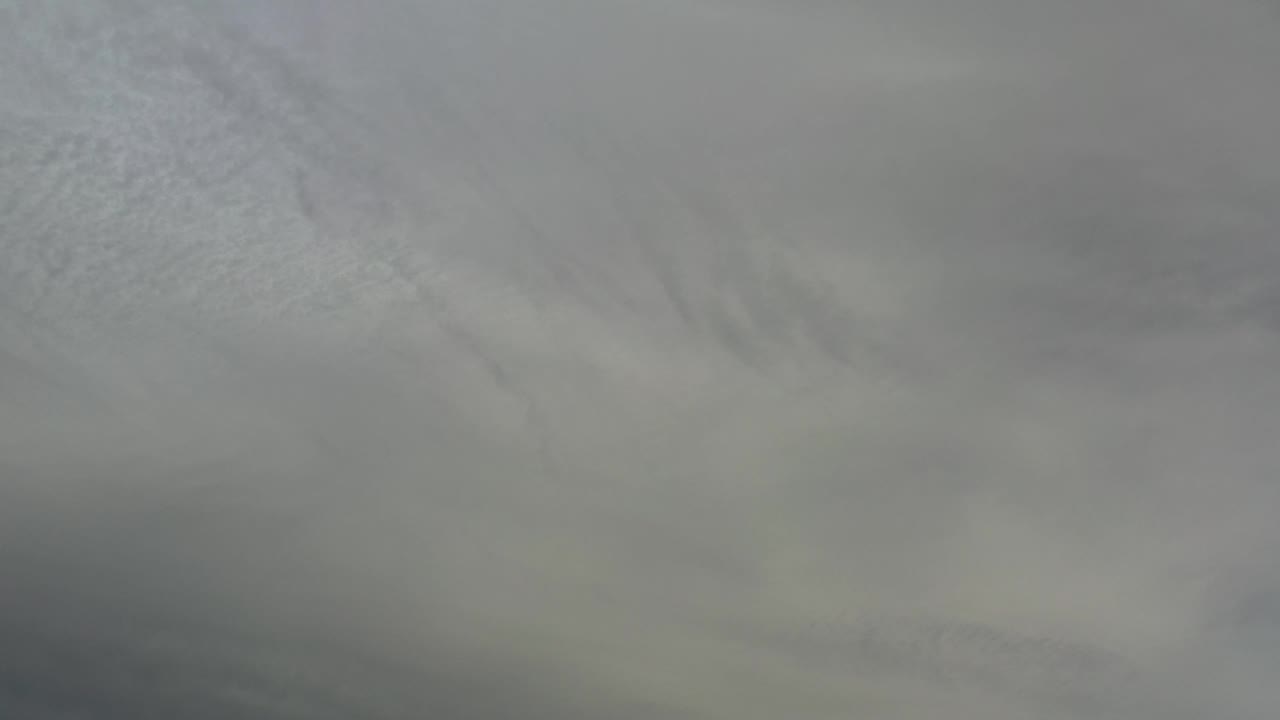 Soft cloud cover fills the second frame in Los Cabos, Mexico, with faint tonal bands and no visible people.