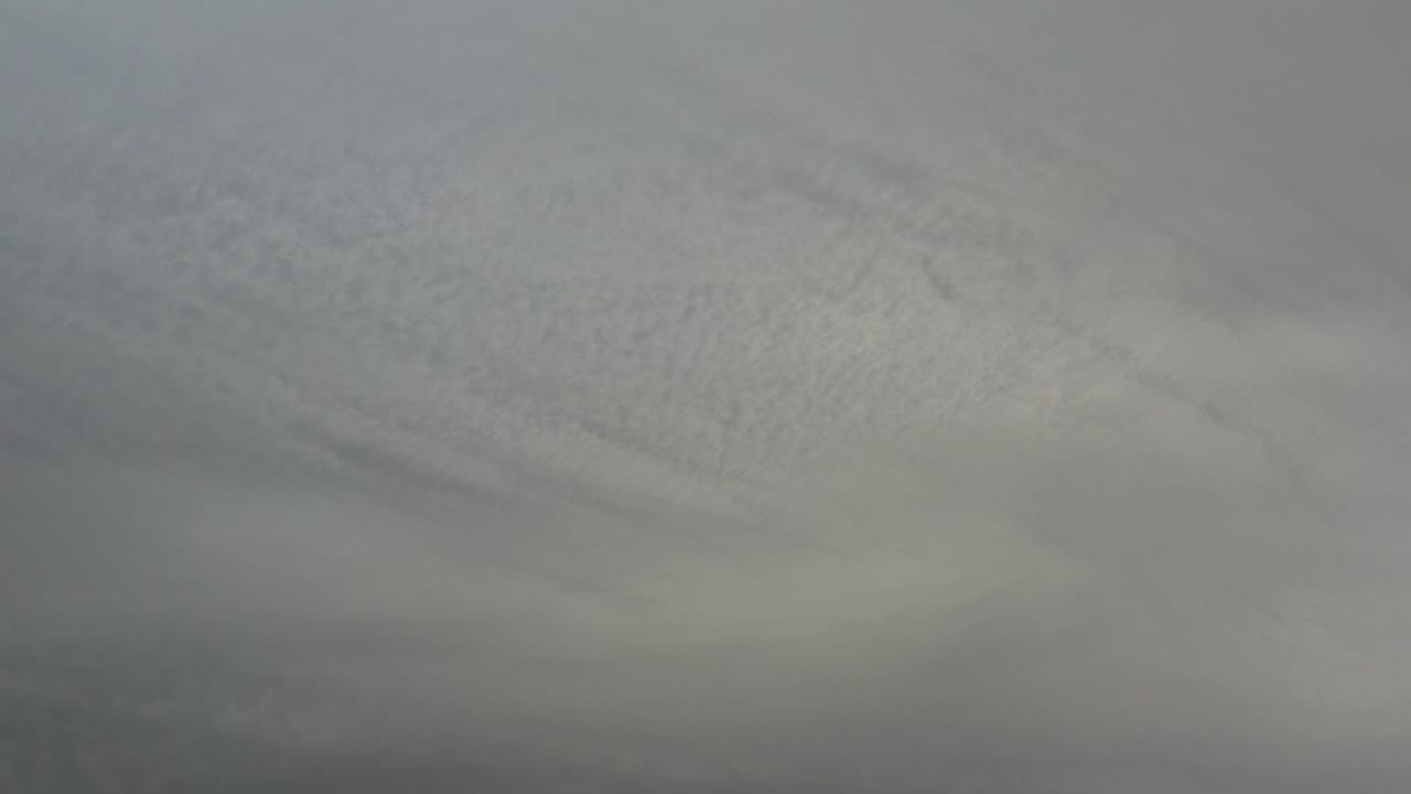 Gray cloud layers fill the opening frame from Los Cabos, Mexico, with darker cloud bands near the lower edge and no visible people.