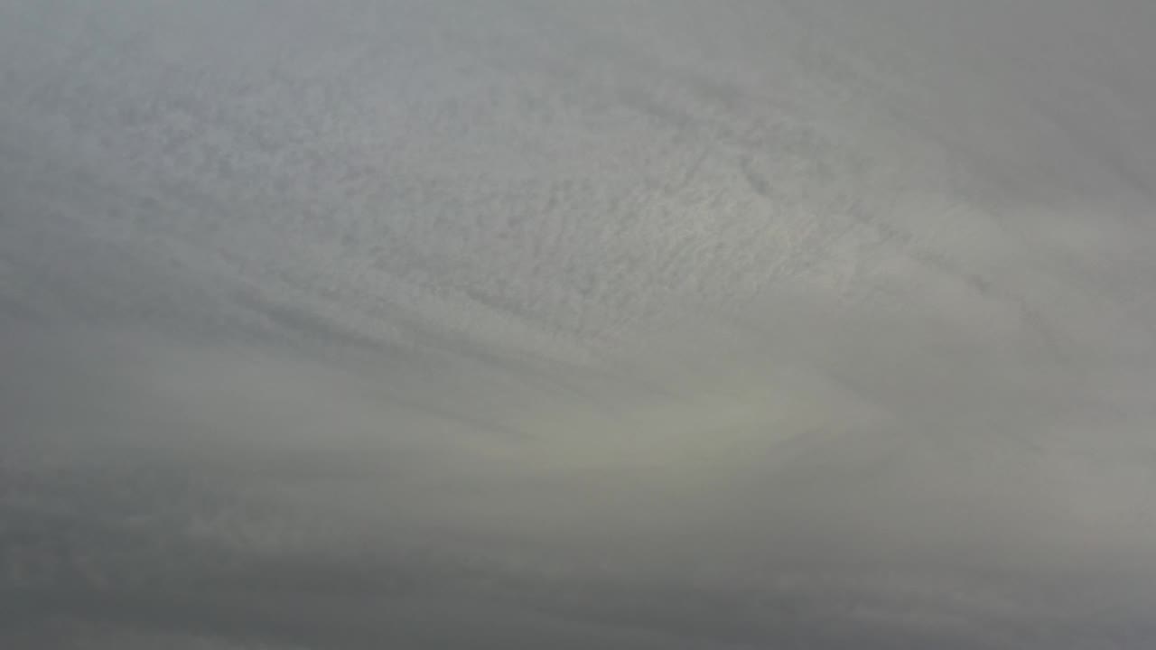 Dark grey cloud layers remain full frame over Los Cabos, Mexico, with a slightly paler patch near the center and no visible people.