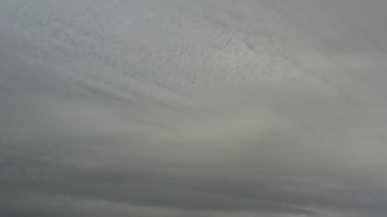 Layered gray storm clouds fill the sky over Los Cabos, Mexico, with darker cloud bands low in frame and no visible people.